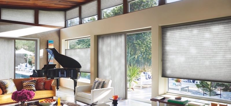 Family room with grand piano with Duette shades.